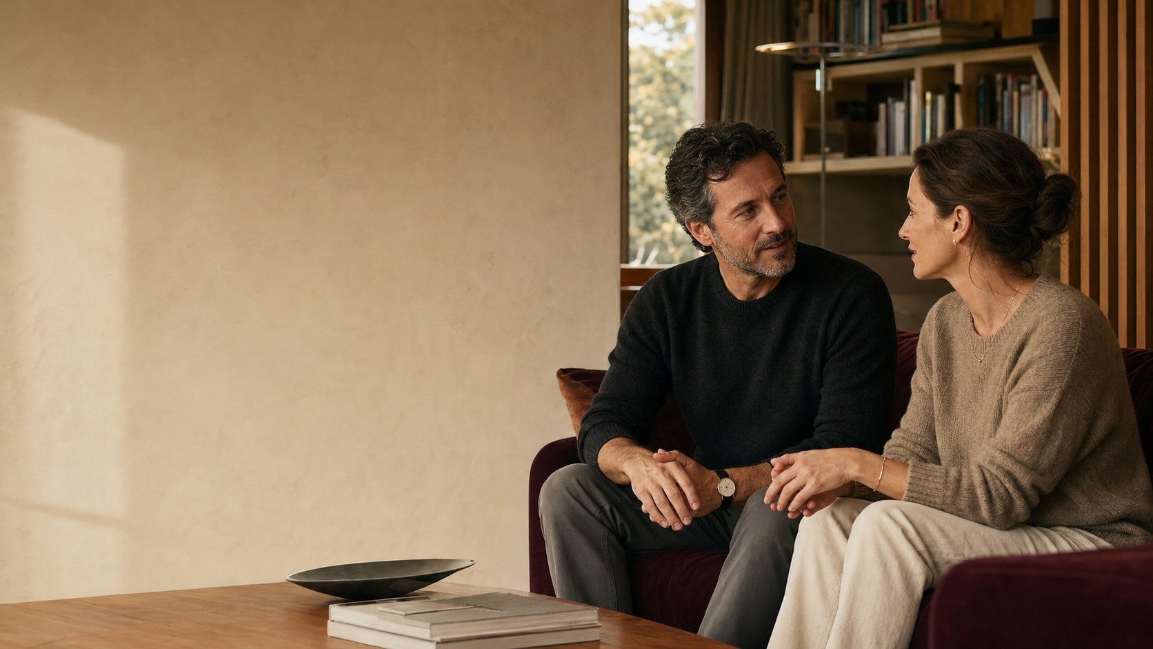 A couple having an attentive conversation in a warm interior
